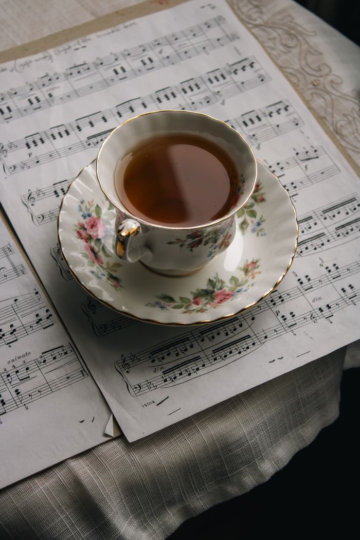 Crafting Captivating Headlines: Your awesome post title goes here A vintage floral teacup atop music sheets, blending elegance and art.