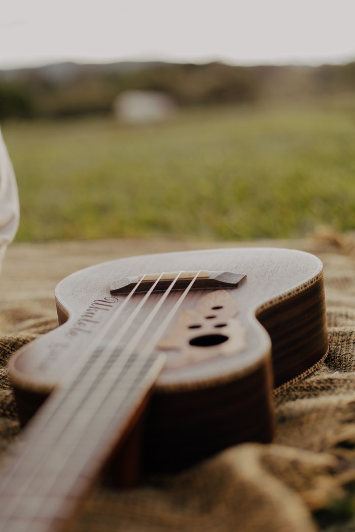 The Art of Drawing Readers In: Your attractive post title goes here Warm tones of an acoustic guitar lying on burlap outdoors, evoking a rustic musical vibe.